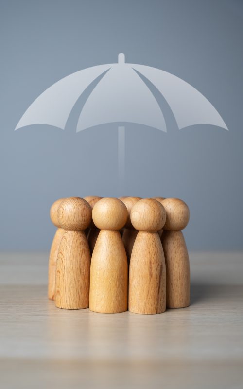 A group of people and an umbrella above.