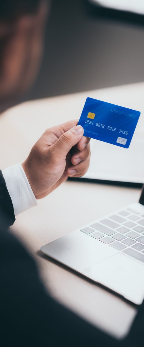 Business people use credit cards to do financial transactions at work