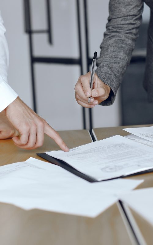 Two business partners signing a document